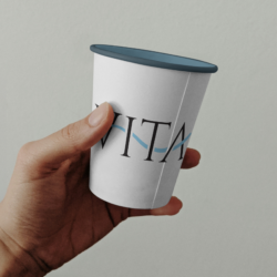 Free Paper Coffee Cup in Hand Mockup